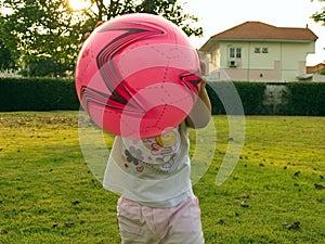 Little girl playing ball