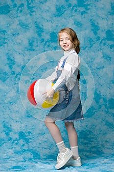 Little girl is playing with a ball.The concept of children`s spo