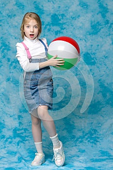 Little girl is playing with a ball.The concept of children`s spo