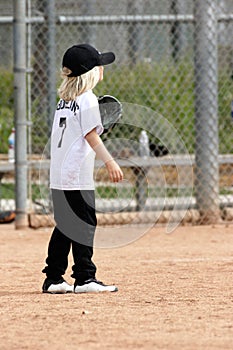 Little girl playing baseball fielder
