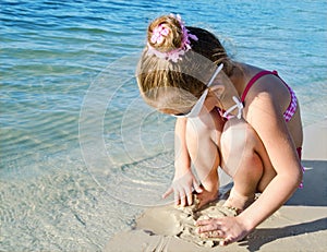 Little girl playing on a beach