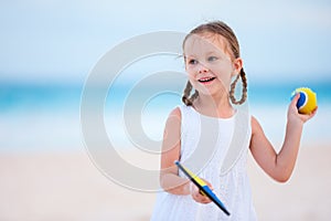 Little girl playing beach tennis