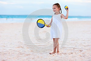 Little girl playing beach tennis