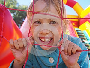 Little girl playing in bouncy castle