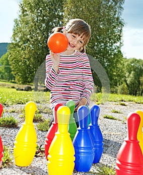 Little girl playing bowling