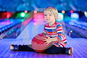 Little girl playing bowling