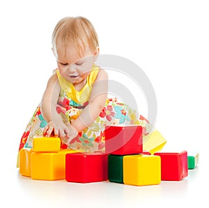 Little girl playing with building blocks