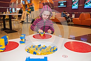 Little girl playing building blocks