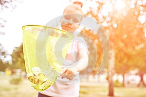 Little girl playing with butterfly net. Summer adventure. Happy toddler