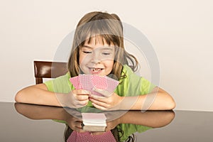 Little girl playing cards