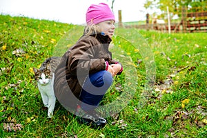 Little girl playing with cat