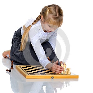 Little girl playing chess