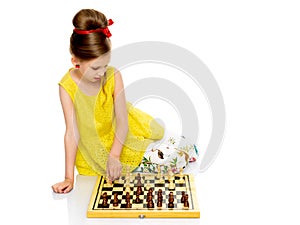 Little girl playing chess