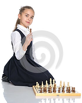 Little girl playing chess