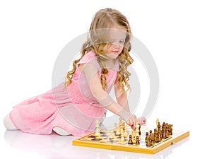 Little girl playing chess