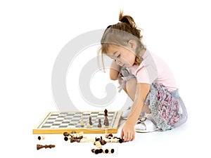 Little girl playing chess