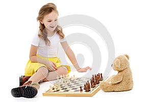 Little girl playing chess