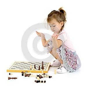 Little girl playing chess