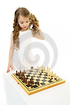 Little girl playing chess