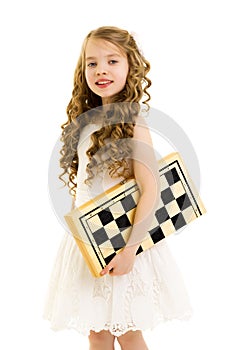 Little girl playing chess