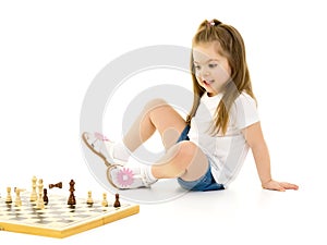 Little girl playing chess