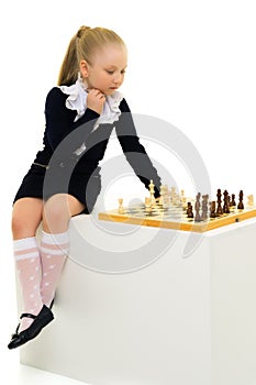 Little girl playing chess