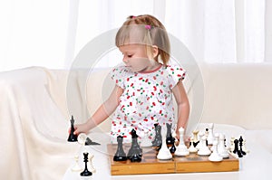 Little girl playing chess