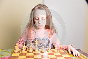 Little girl playing chess