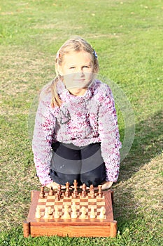Little girl playing chess