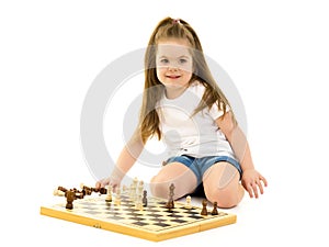 Little girl playing chess isolated