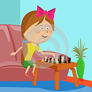 Little girl playing chess sitting on sofa in room