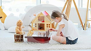 Little girl playing chess with teddy