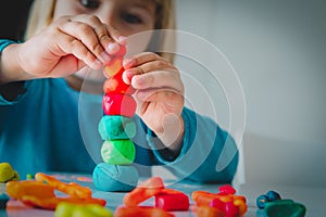 Little girl playing with clay molding shapes, kids crafts