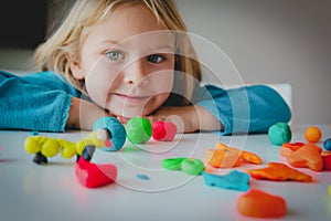 Little girl playing with clay molding shapes, kids crafts