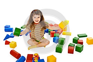 Little girl playing with color cubes on floor