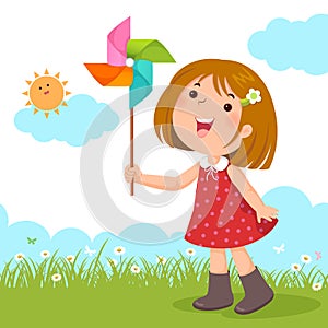 Little girl playing with a colorful windmill toy