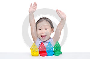 Little girl playing colorful wood blocks