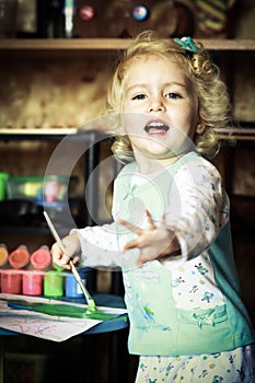 Little girl playing with colors