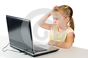 Little girl playing on the computer