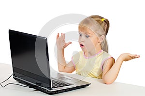 Little girl playing on the computer.