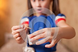 Little girl playing dangerous game with matches