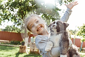 Little girl is playing with a dog. a dog as a gift to children. children`s smile on the nature