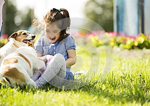 Little girl playing with dogs