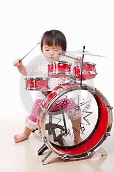 Little girl playing drum