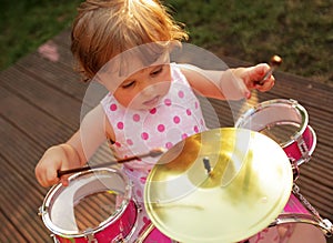 Little girl playing drums