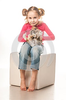 Little girl playing with Easter bunny on a white background