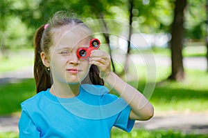 Little girl playing with fidget spinner