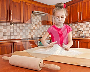 Little girl playing with flour