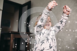 Little girl is playing with foam balls