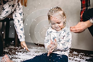 Little girl is playing with foam balls